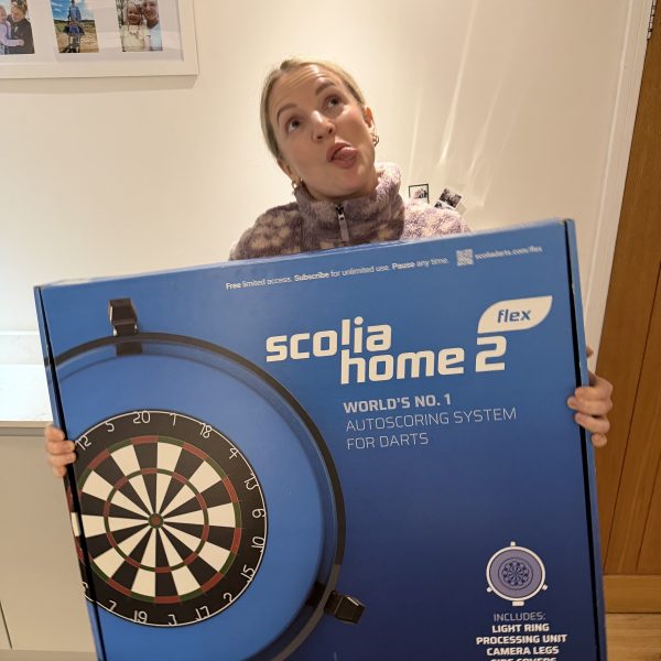 Scolia Home 2 Flex smart dartboard displayed with festive giveaway graphics and text showing “FREE Giveaway – Drawn December 31st.
